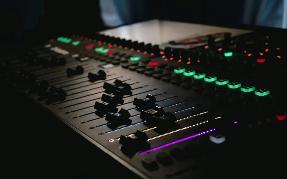 Black and green audio mixer, illustrating preparing audio for digital distribution